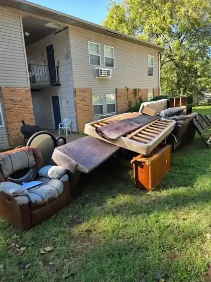 Junk removal pile outside a Huntsville property